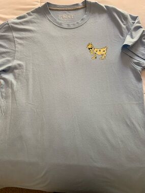 Light Blue Graphic Tee with Small Yellow Goat. Mens medium